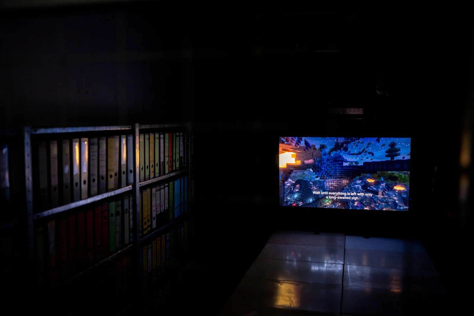 A television displays a nocturnal landscape generated in Minecraft.