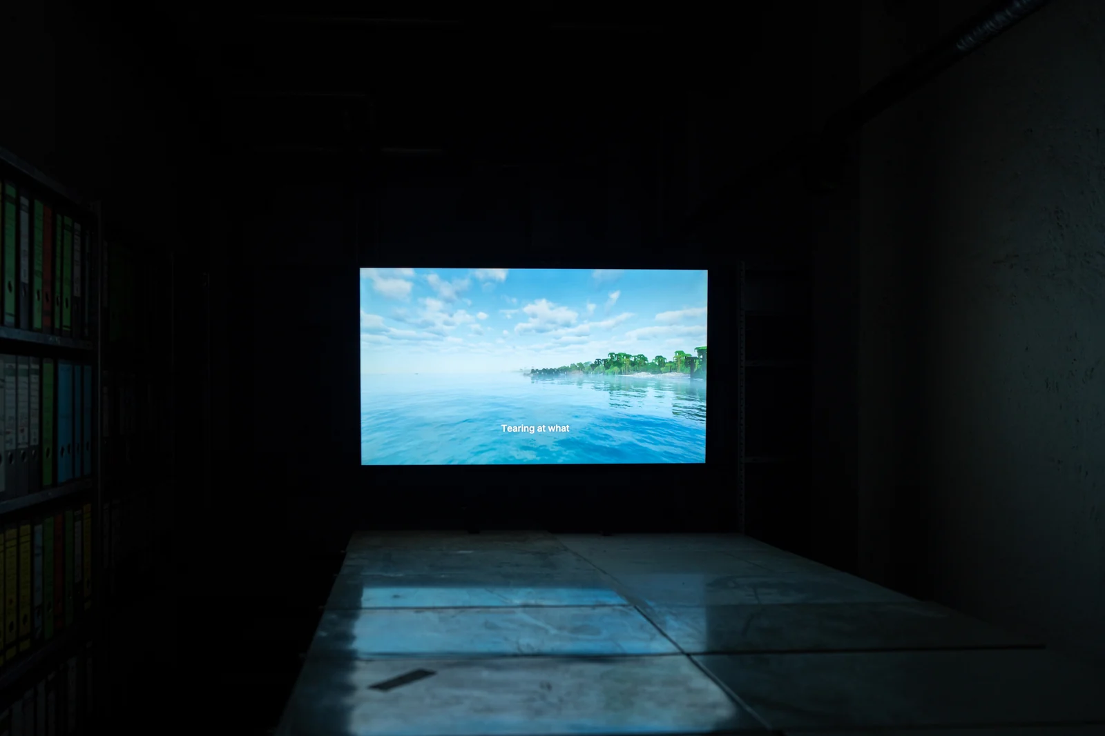 A bright blue digital ocean appears on a television screen.
