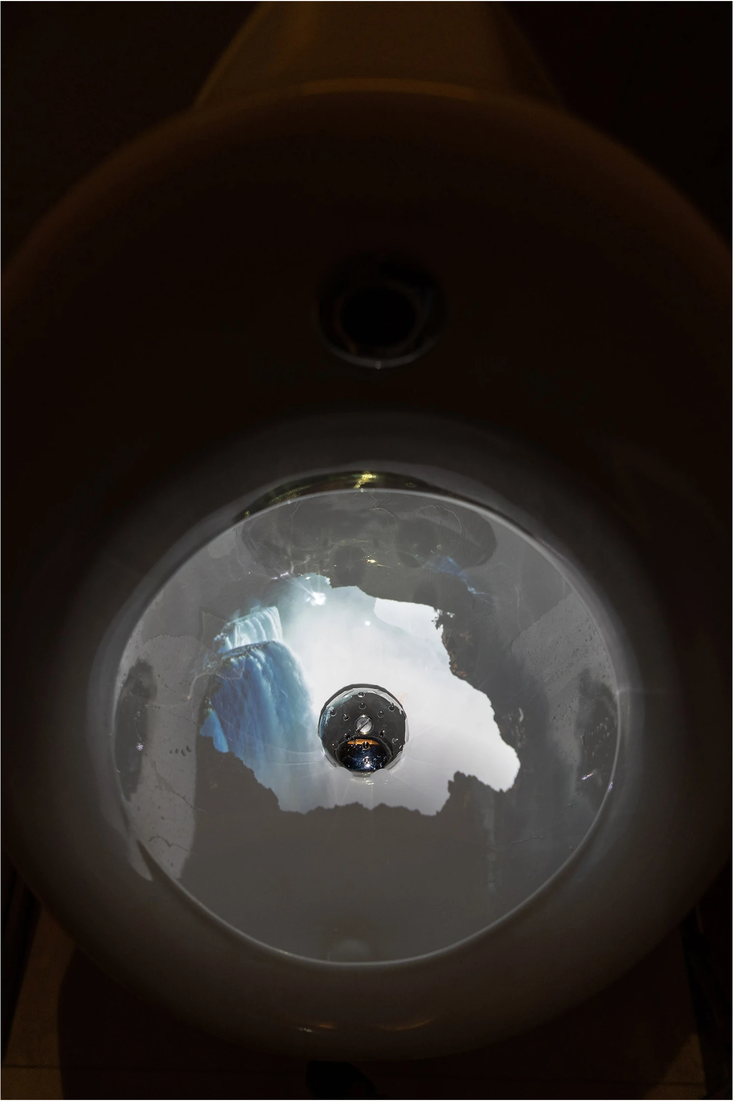 A second photographic view of water imagery inside the basin.